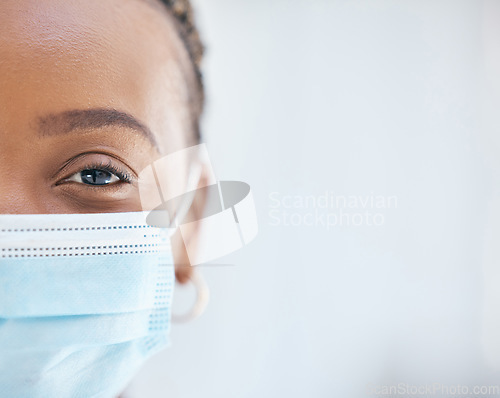 Image of Covid, face mask and portrait of doctor working in hospital with safety, compliance and vision in eye for health, healing and innovation. Black woman in healthcare and medical field during covid 19