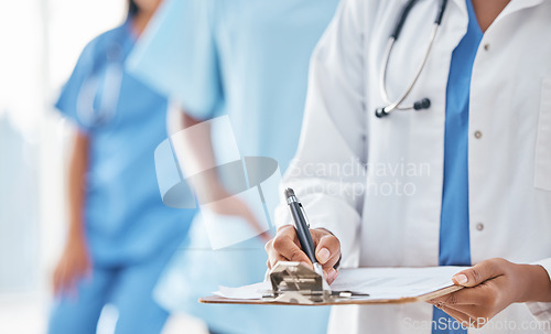 Image of Hands, documents and doctor writing at hospital for compliance, information and insurance. Hand, paper and healthcare woman filling form, clipboard and prescription while planning appointment