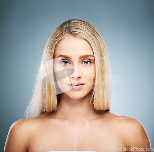 Image of Portrait, face and beauty with a model woman in studio on a gray background to promote natural skincare. Wellness, hair and luxury with an attractive young female inside to endorse cosmetics