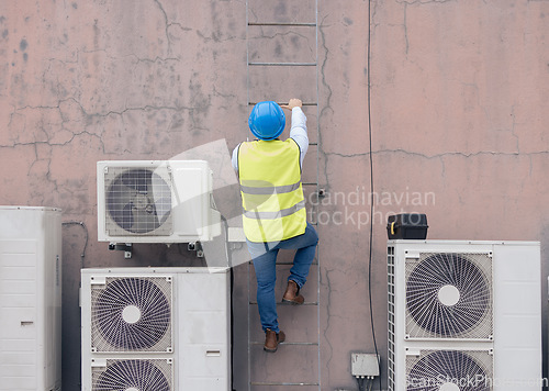 Image of Construction, ladder and building with a man engineer climbing up a wall on a build site. Safety, roof and engineering with a male construction worker or contractor at work on a development project