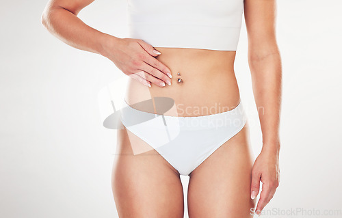 Image of Woman, stomach and model body and slim waist posing against a white mockup space background. Female feeling fresh while show liposuction belly and skin while standing gin underwear with mock up