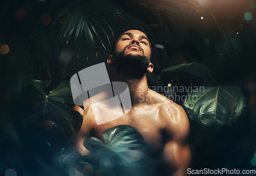 Image of Beauty, man and body in jungle leaf nature for natural skincare cosmetics advertising. Tropical, monstera and handsome black model thinking of sustainable, health and wellness cosmetic.