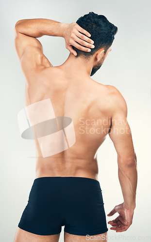 Image of Back, body and underwear with a man model in studio on a gray background for health, wellness or care. Fitness, exercise and strong with a muscular male standing inside to promote healthy lifestyle