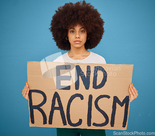 Image of Portrait of a black woman with a stop racism banner and peacefully protesting for human rights in studio. Young afro girl with a cardboard poster fighting for race, social justice or racial equality