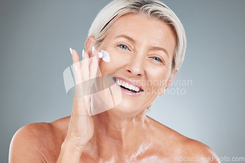 Image of Beauty, senior and portrait of woman with cream on face for skincare, health and cosmetic antiaging. Happy, mature and natural cosmetics for skin model advertising with gray studio mockup.