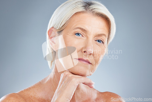 Image of Face, beauty and skincare with a senior woman in studio on a gray background for antiaging treatment. Cosmetics, luxury and natural with a mature female posing to promote a body care product