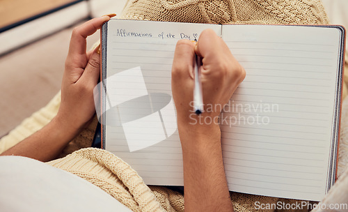 Image of Hands of woman relax, writing in notebook mockup for morning routine on living room sofa. Affirmations, personal goals and book of calm life thoughts or young girl creative thinking journal on couch