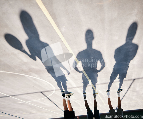 Image of Basketball, shoes and silhouette of team upside down on basketball court training for game or competition. Fitness, sports and shadow of basketball players ready for exercise, workout or practice.