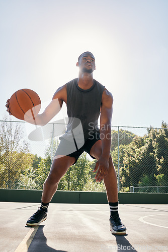 Image of Basketball player, dribble basketball court at training and workout ready for contest, sport or game with ball. Sports, basketball or black man preparation, outdoor or exercise for summer competition