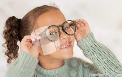 Image of Face portrait, child and girl with glasses for optical health at optometrist office. Eyes wellness, eye care and happy kid with specs, spectacles or prescription lenses to help with ocular vision.