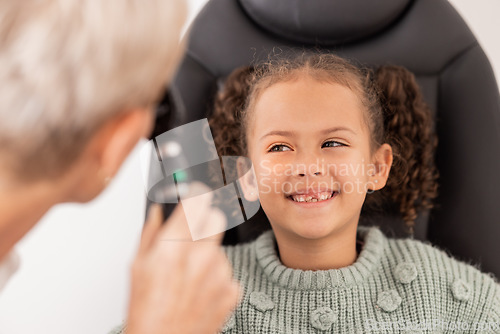 Image of Happy, test and child with eye doctor for eyesight, vision or retina testing at an optometrist appointment. Smile, consulting and young girl with optician for an eye exam or expert eye care treatment