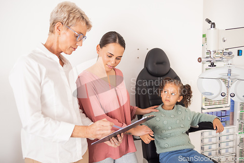 Image of Mother and child consulting an eye doctor with a clipboard after an eye test or exam for healthy vision. Family, optometrist or optician helping a mom and kid with eyesight advice or eye care results