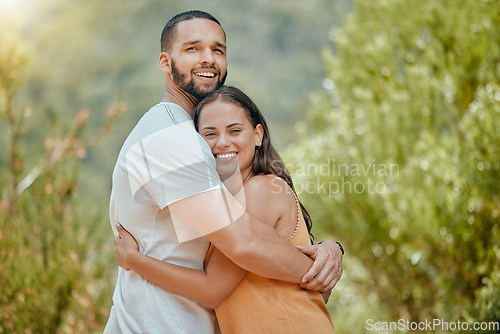 Image of Black couple, hug and smile in woods together, outdoor and bush with love, romance or bonding on vacation in nature. Happy, man and woman embrace in portrait, forest or trees for happiness