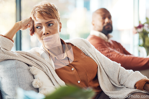 Image of Mature couple, divorce and fighting on sofa in house, home living room or marriage counseling therapy. Stress, frustrated or depression for black woman and man in psychology counselling for cheating