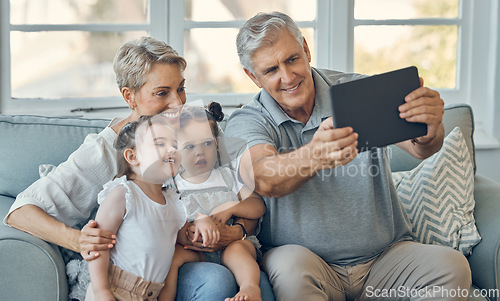 Image of Family, grandparents and children take tablet selfie of happy family bonding, togetherness and enjoy quality time. Love, memory photo and happiness of kids, grandmother and grandfather relax on sofa