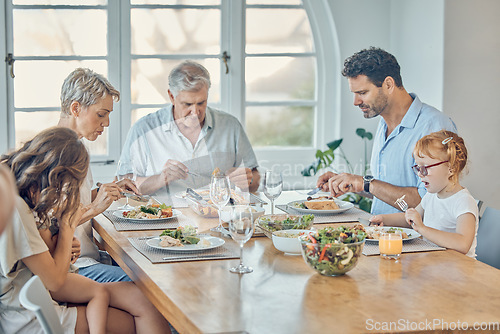 Image of Family, food and children with grandparents, parents and grandkids around a dining room table together for lunch. Love, dinner and eating with a senior man and woman enjoying a meal with relatives