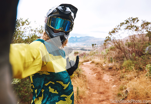 Image of Sports, biker selfie and cycling in nature, countryside or outdoors. Bmx, rock hand sign or self portrait of cyclist on sand or dirt road for adventure, memory or online picture post on social media