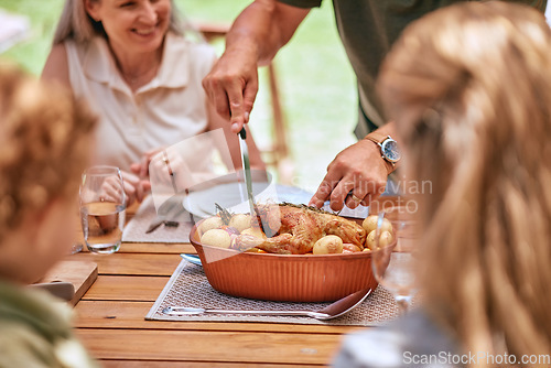 Image of Turkey lunch, family and man cut food for celebration event, happy family reunion and enjoy quality time together on home patio. Love, happiness and group of people eating chicken meal at brunch