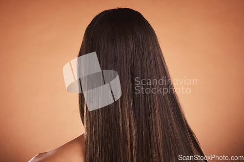 Image of Woman, brown hair balayage and hair care, beauty salon shampoo and shine, smooth texture and extension wig, hair dye color or cosmetics on studio orange background. Back head of model long hair style