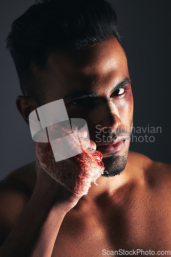 Image of Violence, man and portrait with blood fist of angry fighter with bruise, injury and wound plaster. Boxer, fitness and anger aggression of mma person with intense dark studio shadow background.