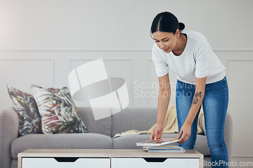 Image of Cleaning, living room books and hygiene woman tidy apartment, home or desk table surface for domestic housework. Magazine, maid service and casual house cleaner working, housekeeping or doing chores