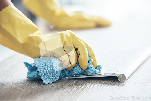 Image of Cleaning service, keyboard computer and hands with cloth for office policy, compliance and covid healthcare in workspace. Modern office desk, workplace and cleaner clean dust or bacteria from desktop