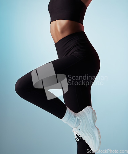 Image of Fitness, running and body of a woman for motivation, exercise and training against a blue studio background. Gym, sports and stomach of a healthy, strong and athlete with a workout and mock up space