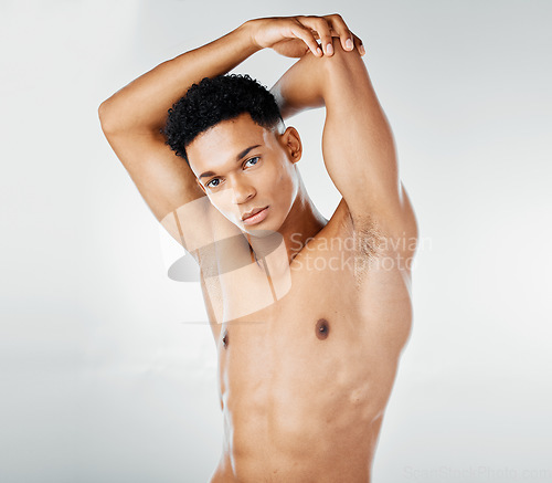 Image of Fitness, health portrait and body of man on gray studio background. Wellness, exercise and young fitness model or bodybuilder from South Africa posing topless for body care, strength and muscle abs