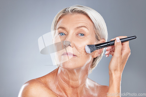 Image of Makeup, cosmetic brush and woman face of a model with healthy skin, wellness and skincare. Beauty, cosmetics and dermatology treatment of an serious old person from Germany start getting ready