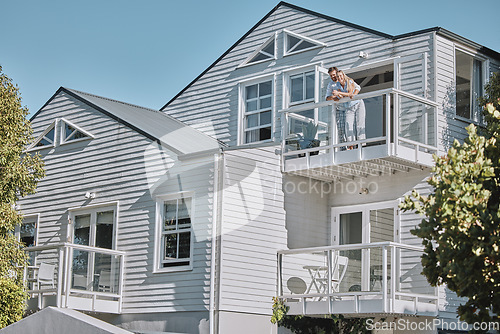 Image of Real estate, house and couple relax on balcony of their dream home, happy, proud and laughing. Property, family and happy man, woman and homeowners enjoy conversation, joke and terrace view together