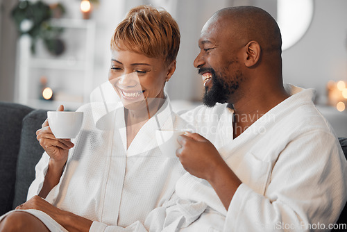 Image of Coffee, love and mature couple on a sofa, happy and laughing while drinking coffee and relax in bathrobe in living room. Black family, tea and senior man and woman enjoy morning conversation on couch