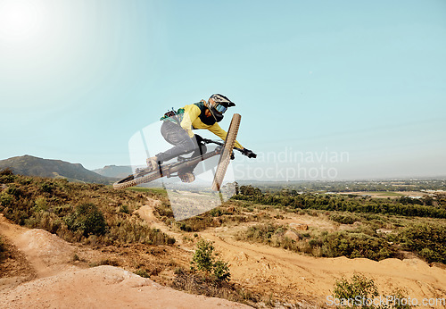 Image of Mountain bike, man and air jump, action and bicycle cycling, challenge and adventure, freedom and dynamic performance on blue sky mockup. Biker, athlete and adrenaline, energy and extreme sports race