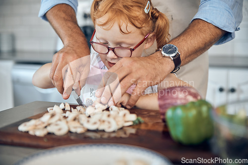 Image of Kid, dad and cooking, cutting board and food in kitchen, family home or house for childhood fun, learning and development. Parent helping little girl chop mushroom vegetables for lunch or dinner meal