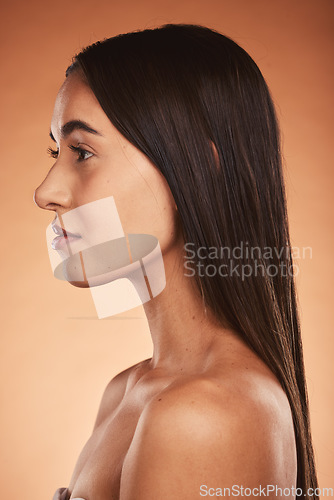 Image of Skincare, hair and woman in studio for beauty, cleaning and grooming on orange background mockup. Skin, facial and wellness model relax, facial and pamper, hair care, hygiene, and space with mock up