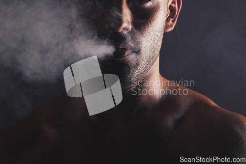 Image of Smoke cloud, face and man in studio for addiction, smoker and bad habit on black studio background mockup. Tobacco, vape or marijuana with guy model pose with space for awareness, cancer and health