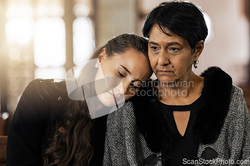 Image of Sad, empathy and funeral with women in church for mourning, grief and death. Loss, respect and console with mother and daughter at chapel for burial ceremony for depression, remember and sorrow