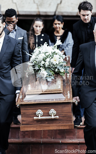 Image of Death, funeral and people with coffin to cemetery, graveyard and morgue for burying, cremation or ritual. RIP, mourning and burial of dead in casket at church ceremony, respect and christian religion