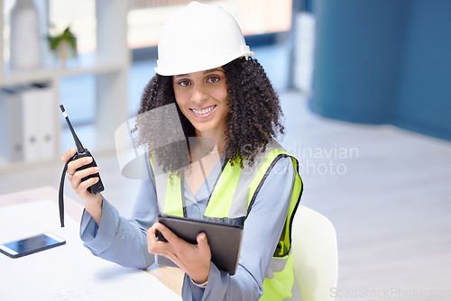 Image of Engineer, walkie talkie and tablet with a black woman working in logistics, construction or engineering using technology for communication and innovation. Portrait of a manager at her office desk