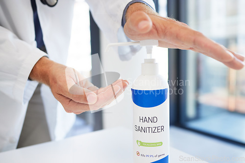 Image of Doctor, hands and sanitizer for hygiene protection against virus, disease or bacteria at the workplace. Hand of healthcare professional using sanitary equipment for medical wellness and clean safety