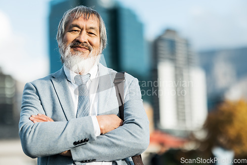 Image of Mature asian businessman, portrait and proud man in the city during a commute or journey to work. City background, executive businessperson and arms crossed while leading on an urban background