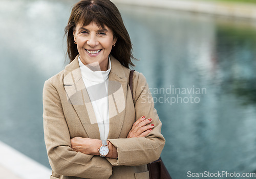 Image of Business woman, smile and happiness while outdoor in city for travel, opportunity and success with arms crossed. Entrepreneur or leader portrait with pride for career choice, achievement and goal