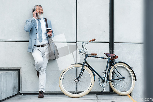 Image of Bicycle, phone call and business man in city for communication, networking and carbon footprint travel marketing update with smile. Happy, healthy senior corporate manager coffee, bike and cellphone