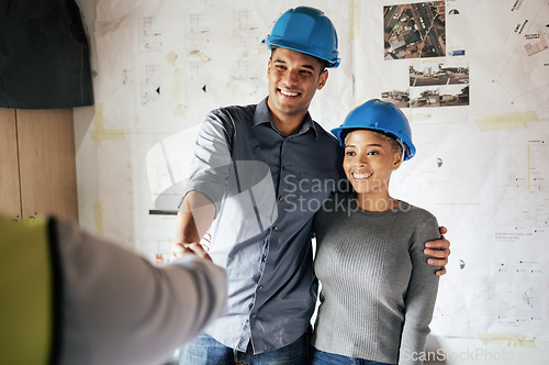 Image of Handshake, construction and couple consulting, planning and doing inspection of home renovation with a contractor. Meeting, thank you and man and woman shaking hands with an architect in their house