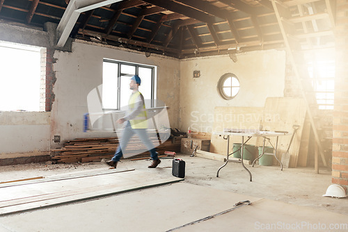 Image of Construction, house and contractor walking in a building with maintenance, renovation and work with sunshine. Architecture, home renovation and fast construction worker on a site working as a builder