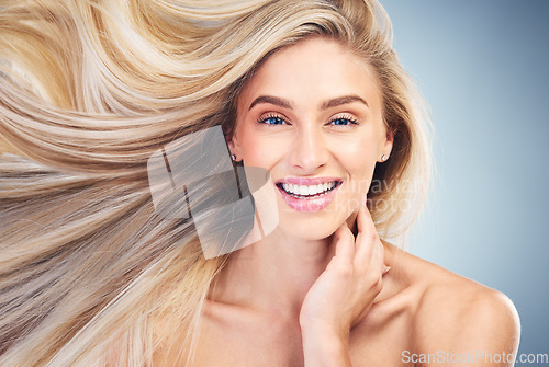 Image of Salon, blowing blonde hair and portrait of woman with smile on face, beauty and wellness. Hair salon, hair care and female with fresh hairstyle pose for shampoo, conditioner and designer hair product