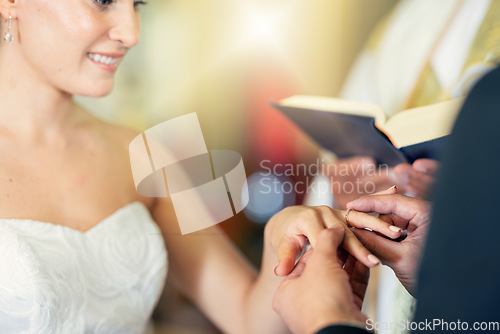 Image of Wedding, marriage and putting ring on finger of bride in celebration of love, romance and commitment. Young couple getting married in church with groom giving jewellery to wife in wedding ceremony
