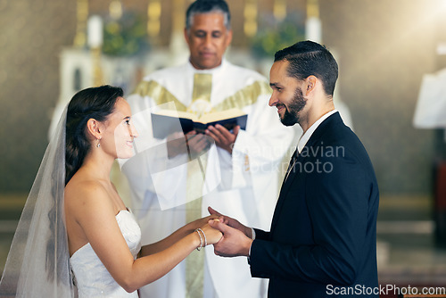 Image of Couple getting married, wedding vows and love commitment at the alter of church during marriage ceremony. Happy bride, groom and Christian priest performing rites, religious and spiritual connection