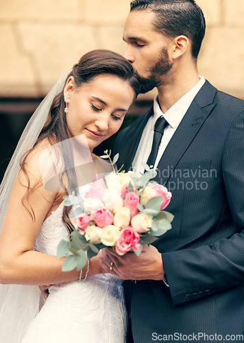 Image of Love, happy and flowers with couple on wedding for affection, kiss and embrace after marriage ceremony. Relationship, lifestyle and hug with man and woman with bouquet for romance, event or reception