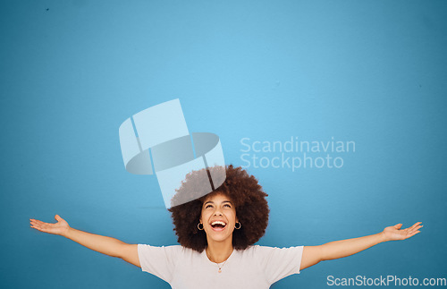 Image of Winner, mockup and excitement with a black woman in celebration in studio on a blue background for marketing or advertising. Motivation, space and product placement with a female cheering in victory
