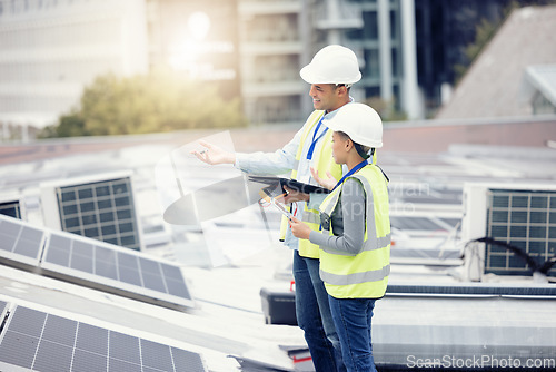 Image of Engineering, solar panels and team planning a maintenance project outdoor in the city on a rooftop. Solar energy, eco friendly and industrial workers in collaboration working on photovoltaic cells.